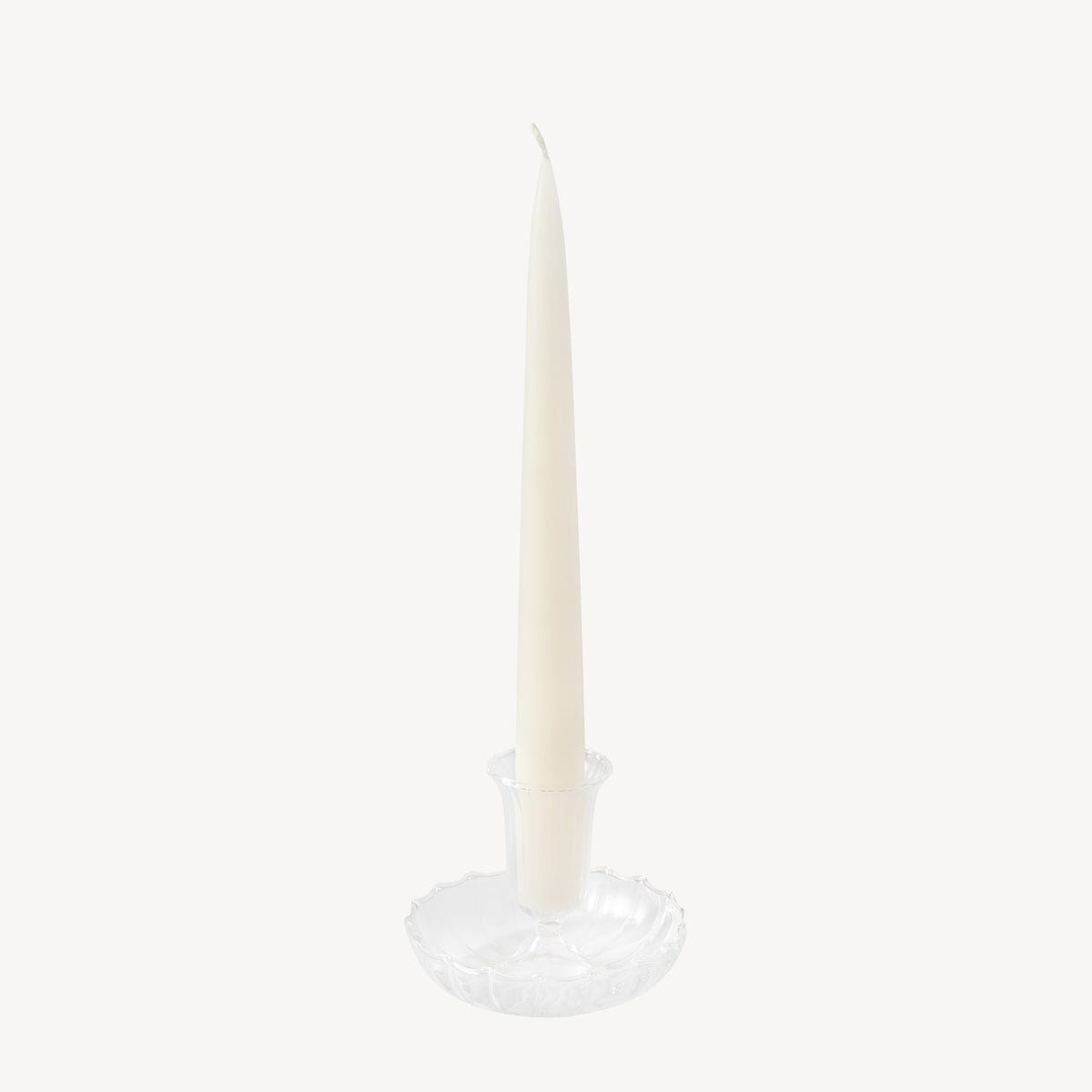 Candle Flair clear glass taper candle holder with a scalloped edge with off white taper