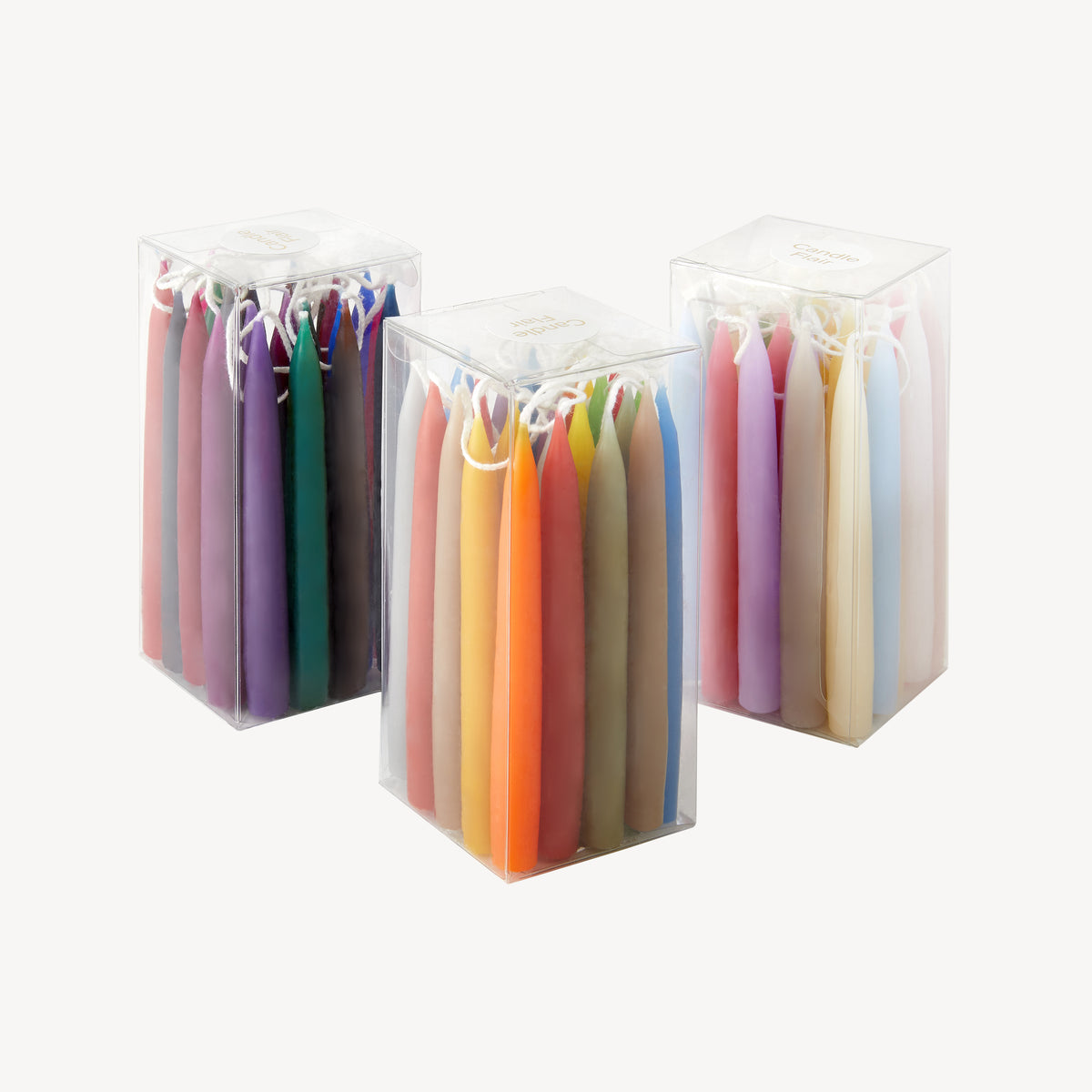 Three boxes of Candle Flair mini candle samples in assorted colours
